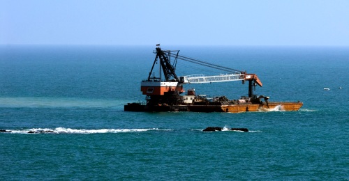 The SDG&E reef barge in position and working off Seal Rock in San Clemente.